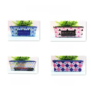 Detailed grid view of four patterned stationery pouches with zippers and geometric designs