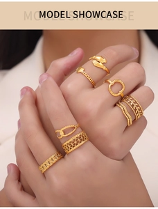 Detail of stacked gold-finish minimalist rings featuring heart and infinity shapes