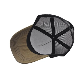 Detail view of khaki trucker hat with black mesh back and stitched brim construction
