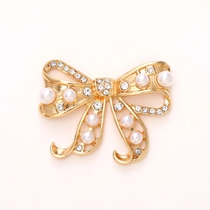 Golden bowknot accessory with white pearls and sparkling rhinestones for DIY crafts