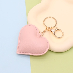 Detailed view of pink PU leather heart keychain with premium gold lobster clasp and ring