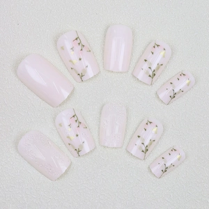 Elegant pink press-on nails with leaf floral patterns, gold foil and 3D lace relief