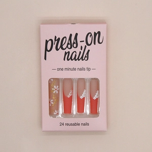 Close-up of Long Coffin press-on nails with orange floral pattern in pink gift box
