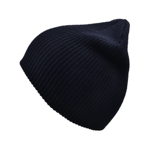 Close-up of the thick ribbed knit texture and warm navy blue fabric of this winter beanie