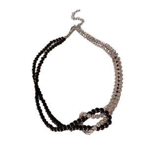 Double-layered knotted choker necklace with black beads and sparkling white diamonds