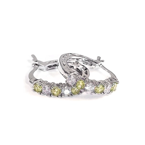 Fashionable silver hoop earrings with yellow and white zircon gemstones on white background