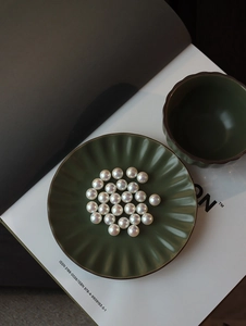 Detailed close-up of high-luster Akoya pearls with mirror-like pink white shine