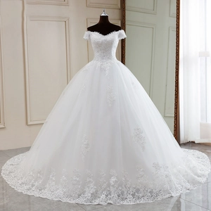 Elegant off-shoulder white bridal gown with lace embroidery and a flowing train