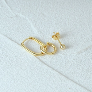 Macro shot of 925 silver earring set with 18K gold plating showing the S925 hallmark