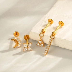G23 titanium gold stud earrings featuring star and moon designs with sparkling crystals