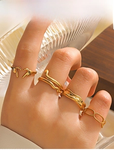 Set of 4 gold plated stainless steel rings with snake and heart designs on a model hand