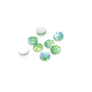 Macro detail of 6mm resin fish scale cabochons with AB finish and silver flat backs
