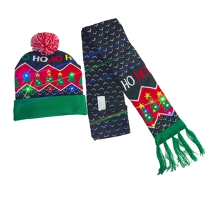 Detail of Christmas knitted hat and scarf set with LED lights and HO HO HO pattern