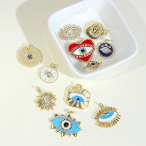 Gold-plated Evil Eye jewelry charms with colorful enamel heart and sparkling crystals