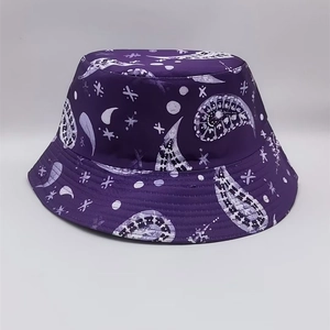 Detail of purple reversible bucket hat with moon, star, and paisley pattern print