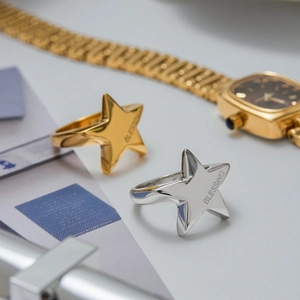 Polished star-shaped stainless steel rings in gold and silver with Blessing engraving