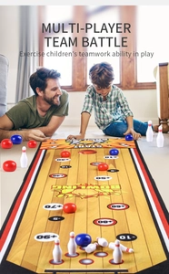 Father and son playing with mini bowling mat and pins on floor for family game night