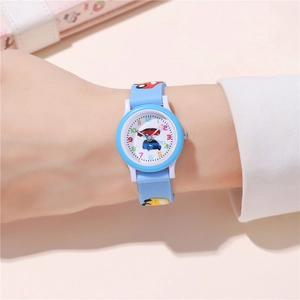 Wrist shot of light blue kids watch featuring red and blue car patterns on dial