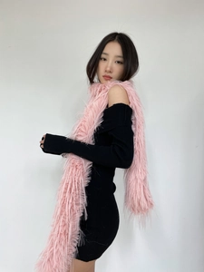 Detail showing plush pink faux mink fur scarf texture against black off-shoulder dress