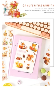 Cute cartoon animal stickers with fox and rabbit patterns on a pink notebook for DIY decor