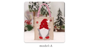 Close-up of Christmas gnome burlap gift bag with red hat and sturdy rope handle