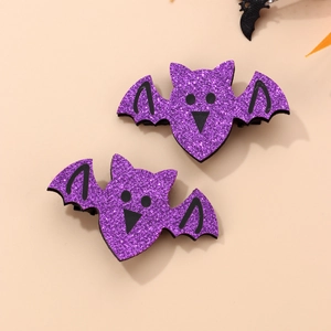 Close-up of two purple glitter bat hair clips for Halloween party accessory