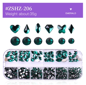 Macro view of 12-slot storage box with emerald green multi-shape glass nail art rhinestones