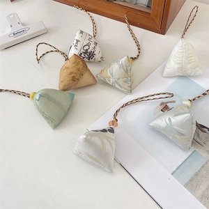 Detail of assorted fabric dragon boat festival charms with traditional patterns and beads