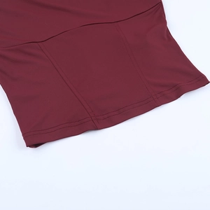 Detail of burgundy dress showing precise double-needle stitching on the elastic knit fabric