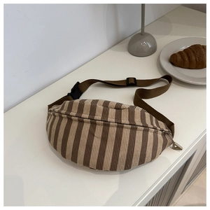 Detail of striped corduroy fanny pack with adjustable strap and plastic buckle closure