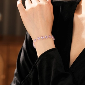 Detailed macro view of an elegant silver bracelet with pinkish-purple oval cut gemstones
