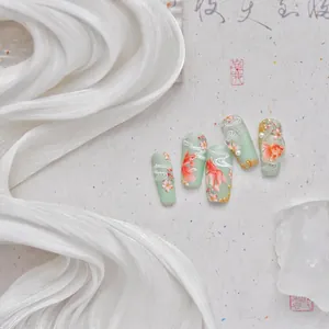 Exquisite handmade press-on nails featuring green koi, cherry blossoms and pearls