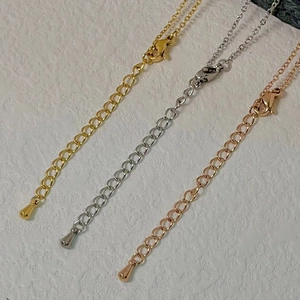 Detailed view of adjustable lobster clasp chain extenders in gold silver and rose gold
