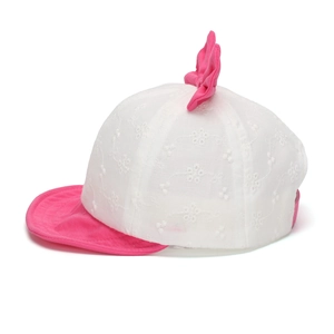 Detailed close-up of embroidered lace patterns and a pink bow on the baby sun hat