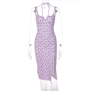 Detail view of purple floral dress with thin straps, ruched bust, and side split design