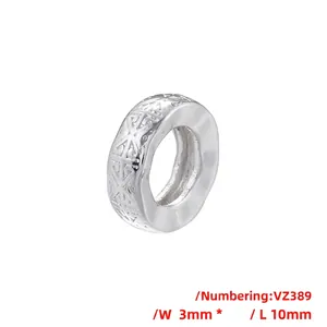 Close-up of VZ389 silver bead with geometric texture measuring 3mm by 10mm