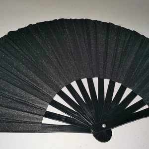 Detail of 33cm Kung Fu fan showing shiny laser texture on black surface and sturdy ribs