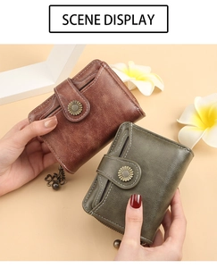 Short fold wallet detail with sunflower metal buckle and four-leaf clover pendant