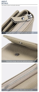 Detail view of durable metal zipper and snap button on light brown leather wallet