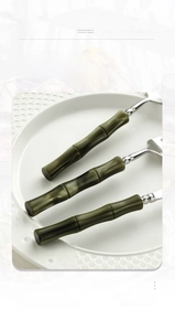 Detail of polished 304 stainless steel cutlery set with olive green bamboo handles