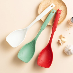 Three heat-resistant silicone spatulas in white, green, and red for non-stick cookware