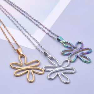 Detailed view of flower pendants in gold, silver, and rainbow steel with hammered texture