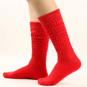 Detail view of red thick slouch socks showing knitted cotton texture and ribbed pattern