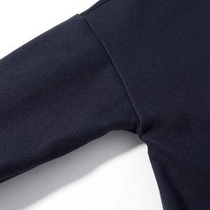 Detailed close-up of premium navy blue fabric and precise stitching on the jacket seam