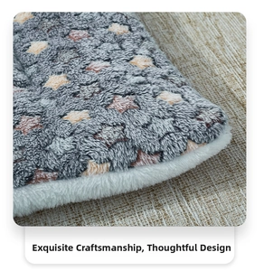 Close-up of gray star-patterned plush pet blanket with soft white faux fur edges