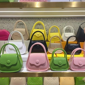 Shelf display of mini macaron jelly bags in green pink yellow white and black colors