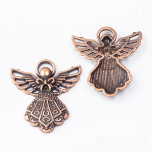 Macro view of vintage bronze angel charms with detailed wing texture and back surface