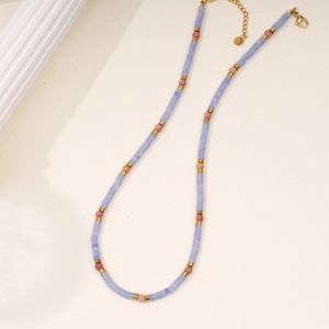 Detail of beaded necklace featuring blue square stones, pink beads, and golden lobster clasp