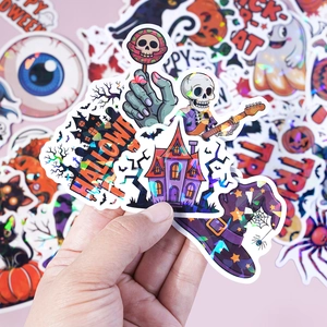Detailed holographic Halloween stickers featuring skulls and pumpkins with a rainbow finish