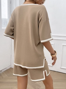Detail of the back view of a khaki knit loungewear set with white contrast trim details